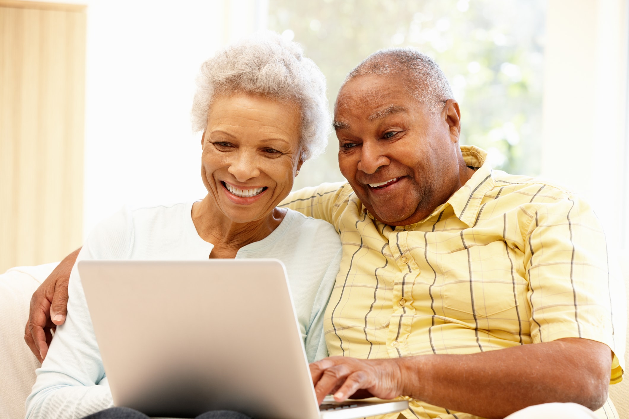 Senior African American Couple Laughing On Their Computer - Dr. Michele ...